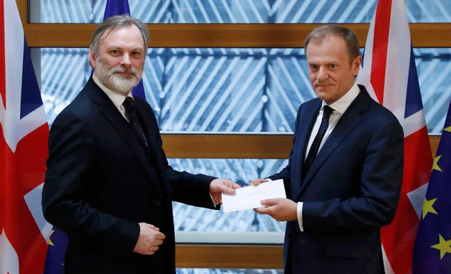 Britain's permanent representative to the European Union Tim Barrow, left, hand delivers British Prime Minister Theresa May's Brexit letter in notice of the UK's intention to leave the bloc under Article 50 of the EU's Lisbon Treaty to EU Council President Donald Tusk, in Brussels, Belgium. (AP)