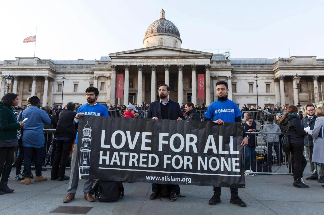 Members of a Muslim group ‘Al Islam’ hold up a sign which reads “Love for all, hatred for none” during a vigil in Trafalgar Square in central London.(AFP)