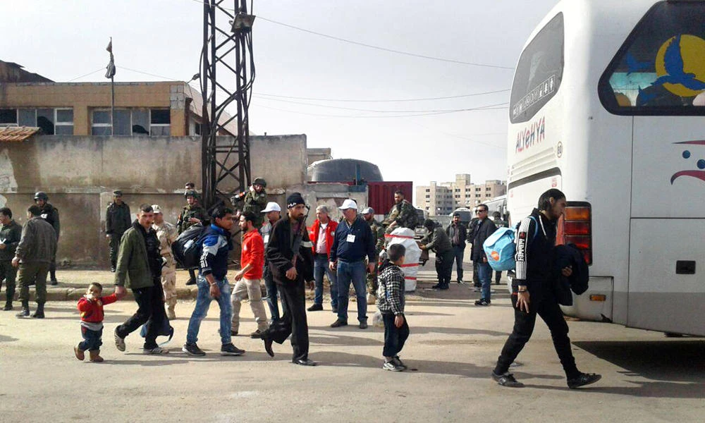 Rebel fighters and their families evacuate the Waer district in the central Syrian city of Homs, in this handout picture provided by SANA on March 27, 2017. A new deal brokered by Qatar and Iran allows the residents of Zabadani, Madaya, Fuaa, and Kafraya to quit their hometowns over the course of 60 days from next Tuesday. (SANA/Handout via Reuters)