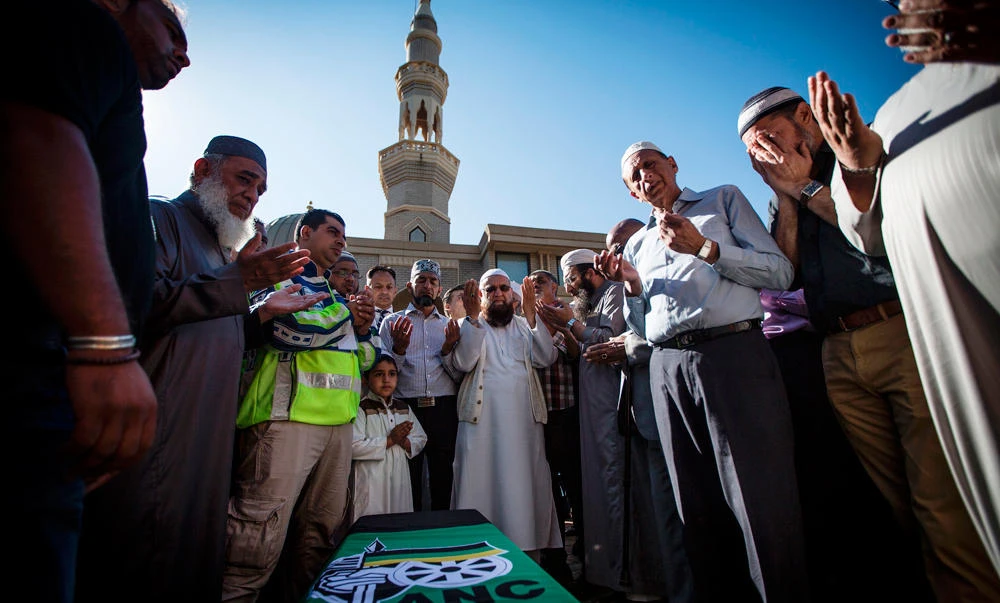 Muslims pray by the coffin of S. African anti-apartheid activist Ahmed Kathrada at a mosque in Houghton on Wednesday. (AFP)