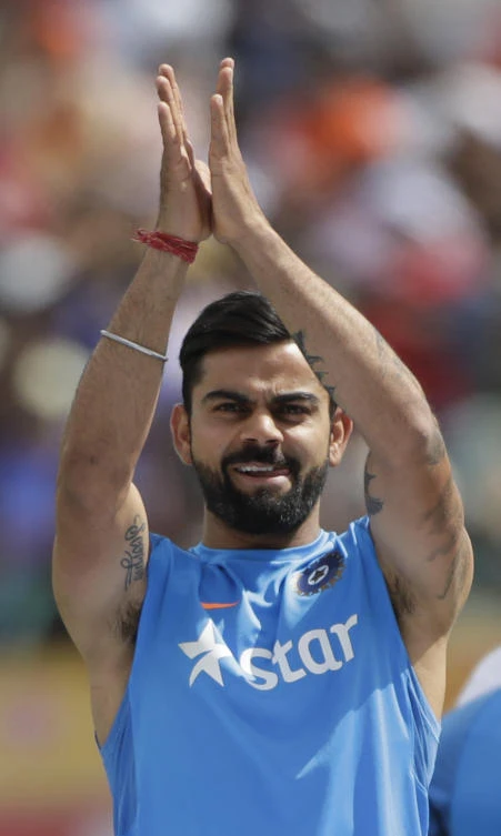 India's captain Virat Kohli, celebrates after winning the Test cricket series against Australia in Dharmsala on Tuesday. (AP)