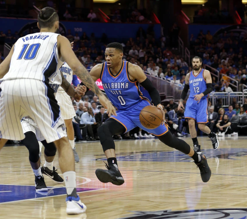 Oklahoma City Thunder's Russell Westbrook (0) drives past Orlando Magic's Evan Fournier (10) during the first half of their NBA game in Orlando on Wednesday. (AP)
