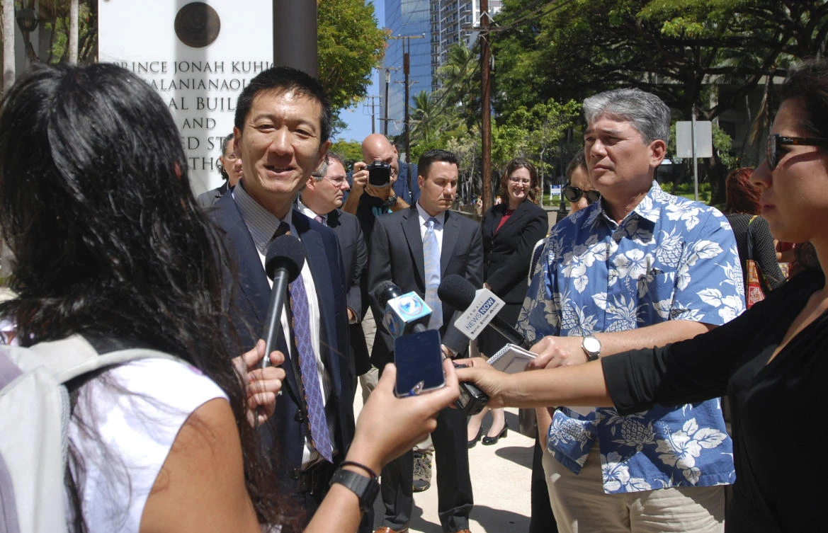 Hawaii Attorney General Douglas Chin speaks outside federal court in Honolulu. (AP Photo/Caleb Jones)