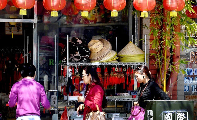 Members of the local Asian community walk on the streets of Chinatown in Los Angeles, California. (AFP)