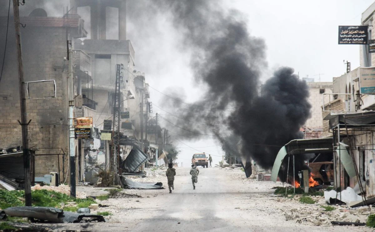 Syrian opposition fighters running amdist destruction. Warplanes pounded opposition areas north of the Syrian city of Hama on Thursday. (AFP)