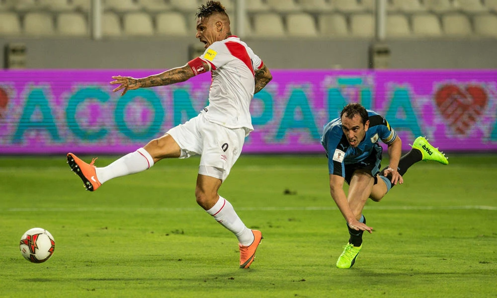 Peru's forward Paolo Guerrero (L) shoots to score against Uruguay as Uruguay's Diego Godin fails to stop him during the 2018 FIFA World Cup qualifier football match Peru vs Uruguay in Lima on March 28, 2017. ( AFP)