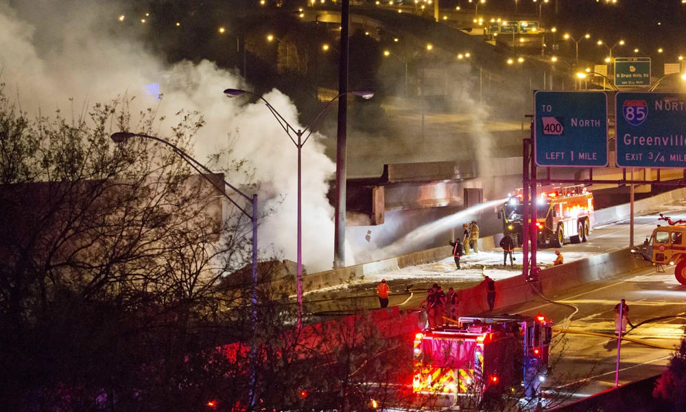 Smoke billows from a section of an overpass that collapsed from a large fire on Interstate 85 in Atlanta, US, on Thursday. (AP Photo/David Goldman)