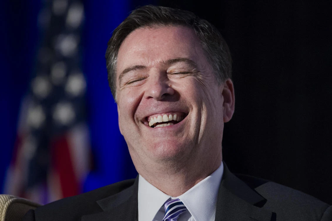 FBI Director James Comey laughs while addressing the Intelligence and National Security Alliance Leadership dinner in Alexandria, Virginia, Wednesday, March 29, 2017. (AP)