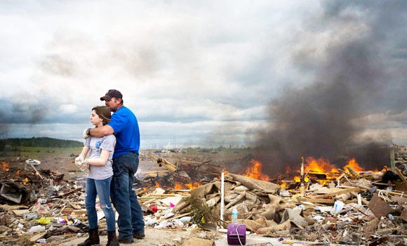 Americans embrace after a tornado in Arkansas.(Reuters)