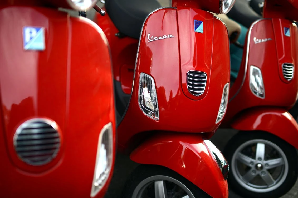 This file photo taken on December 09, 2013 shows Red Vespa parked in a street of Rome. (AFP)