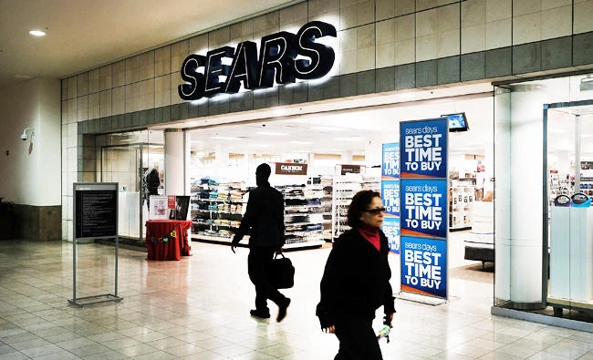 People walk by a Sears store in a nearly empty Westfield Meriden shopping mall on March 28, 2017 in Meriden, Connecticut. (AFP)