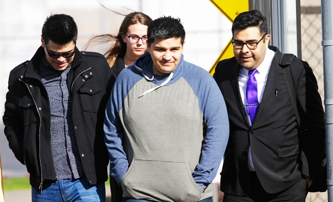Daniel Ramirez Medina, second from right, walks out of the Northwest Detention Center in Tacoma, Wash., with his attorney, Luis Cortes, right, and his brother, left, who has not been identified by name, after Ramirez was released from federal custody, on Wednesday. (AP)