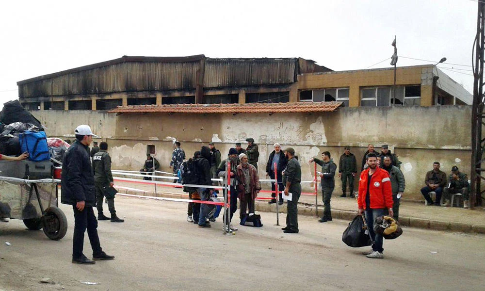 Rebel fighters and their families evacuate the Waer district in the central Syrian city of Homs, in this handout picture provided by SANA on March 27, 2017. (Reuters)