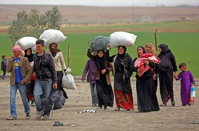 Displaced Syrians, who fled the Daesh stronghold of Raqqa, arrive at a temporary camp in the village of Ain Issa on Friday. (AFP)