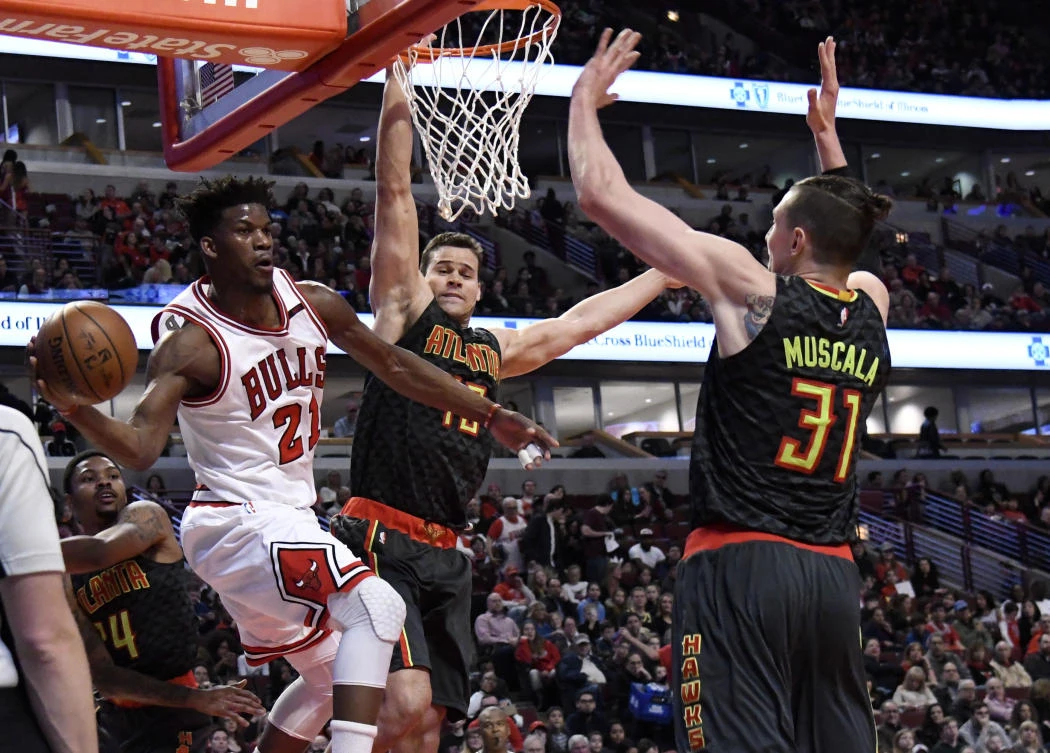 Chicago Bulls forward Jimmy Butler (21) looks to pass the ball around Atlanta Hawks forward Mike Muscala (31) during the first quarter at the United Center on Saturday. (USA TODAY Sports)
