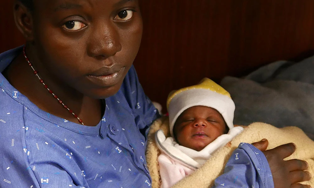 Mariam Ohene, a Nigerian migrant holds her baby girl aboard the former fishing trawler Golfo Azzurro, about 32 hours after her rescue along with other migrants from their drifting plastic rafts by Spanish NGO Proactiva Open Arms, in the Mediterranean Sea, off the Libyan coast on Sunday. (REUTERS/Yannis Behrakis)
