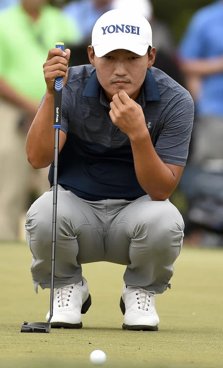 Sung Kang reads the green on the second hole during the third round of the Houston Open golf tournament Saturday in Humble, Texas. (AP)