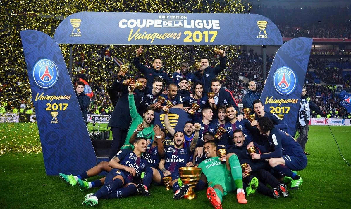 Paris Saint-Germain's players celebrate with the trophy after winning the French League Cup final football match between Paris Saint-Germain (PSG) and Monaco (ASM) on Saturday at the Parc Olympique Lyonnais stadium in Decines-Charpieu, near Lyon. (AFP)