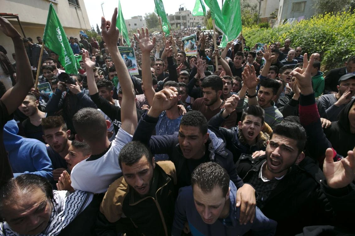 Palestinian supporters of Mazen Faqha, who was shot dead by unknown gunmen in the Gaza Strip a day earlier, march during a demonstration in the West Bank village of Tubas.(AFP)