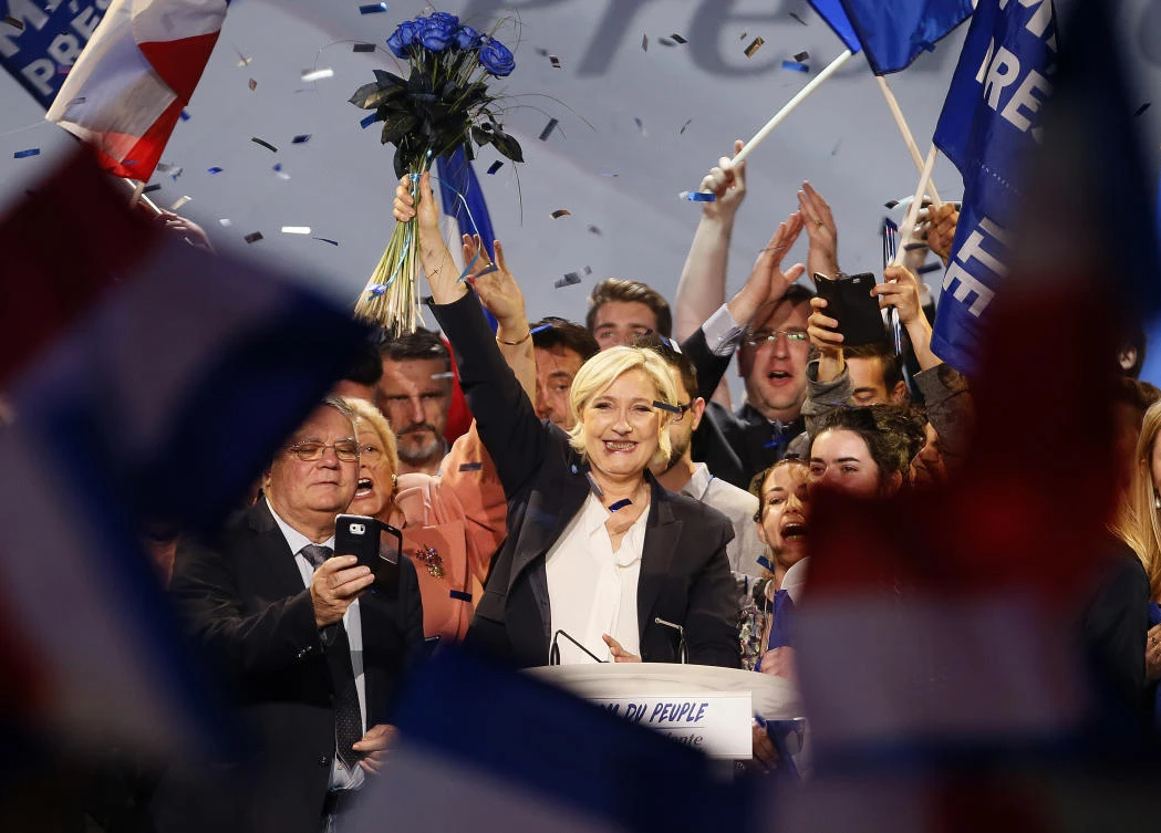 Far-right candidate for the presidential election Marine Le Pen holds flowers after she delivers a speech during a meeting in Bordeaux, southwestern France.(AP Photo)