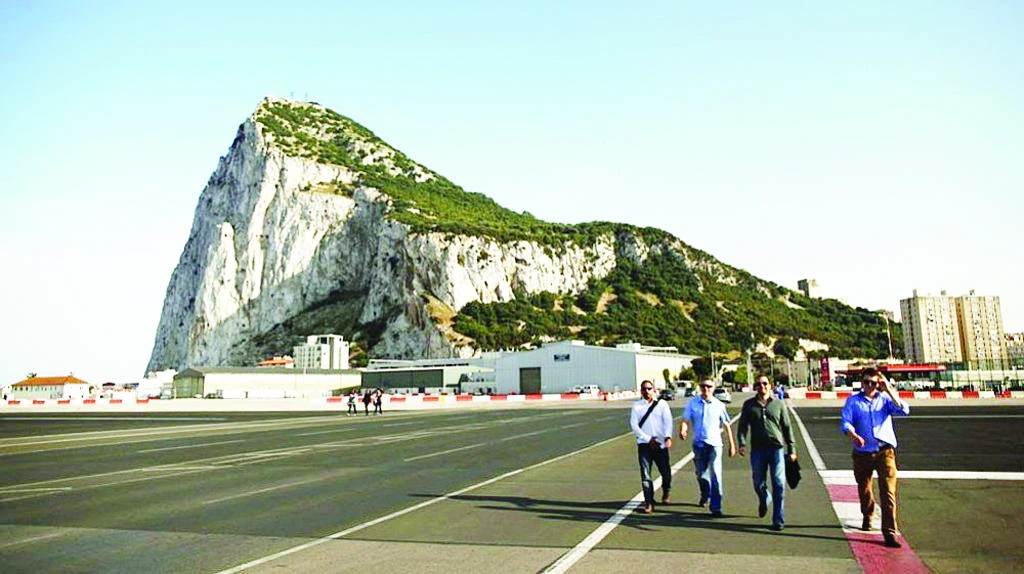 Pedestrians cross a road near the Gibraltar airport in this file photo. (Reuters)