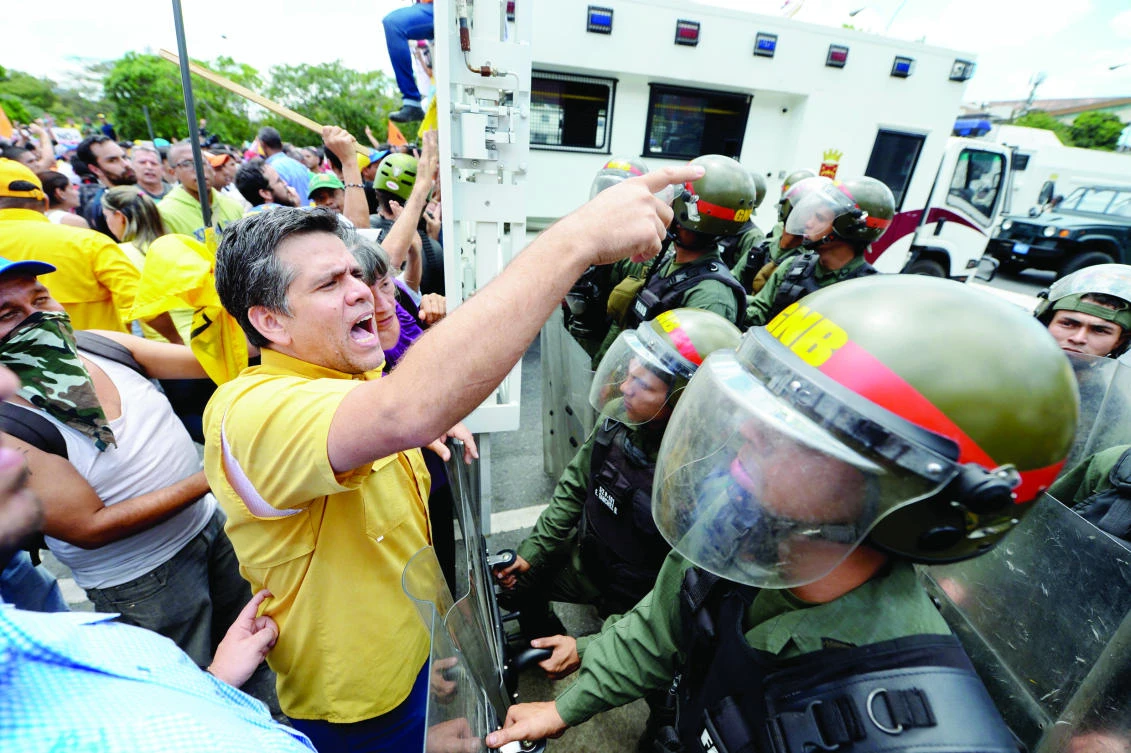 Venezuelan opposition activists take part in a protest against the government of President Nicolas Maduro in Caracas. (AFP)