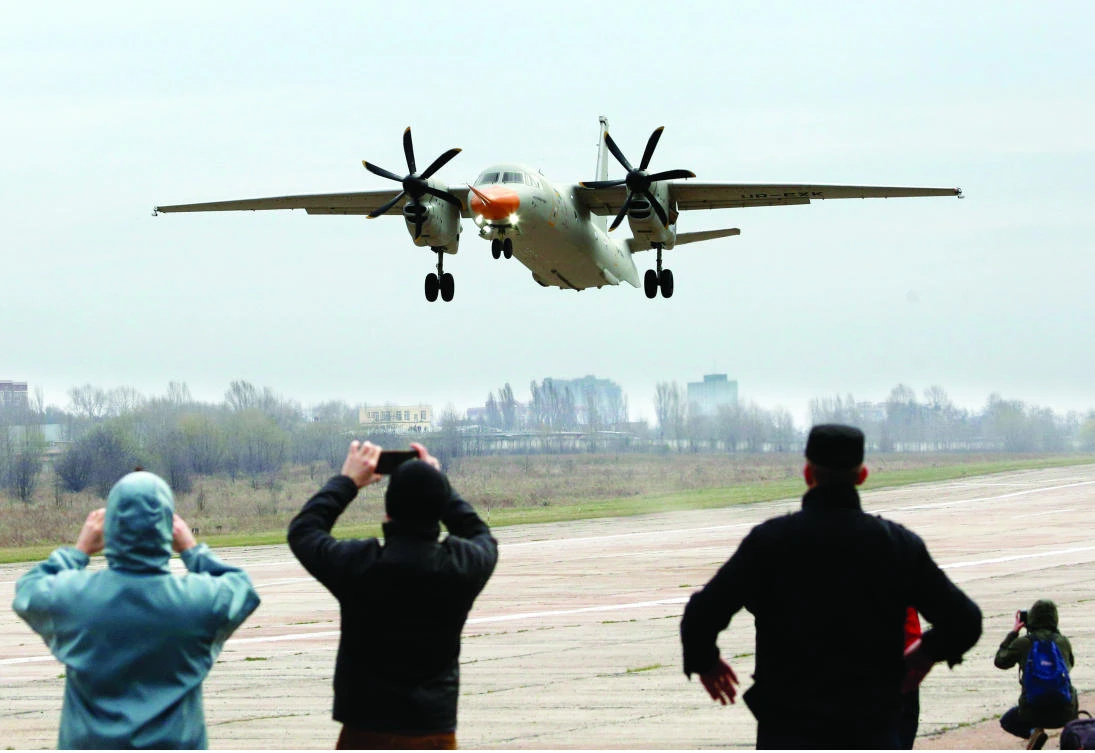 People photograph the inaugural flight of a new Saudi-Ukrainian Antonov AN-132 airplane in Kiev, Ukraine. (AP)
