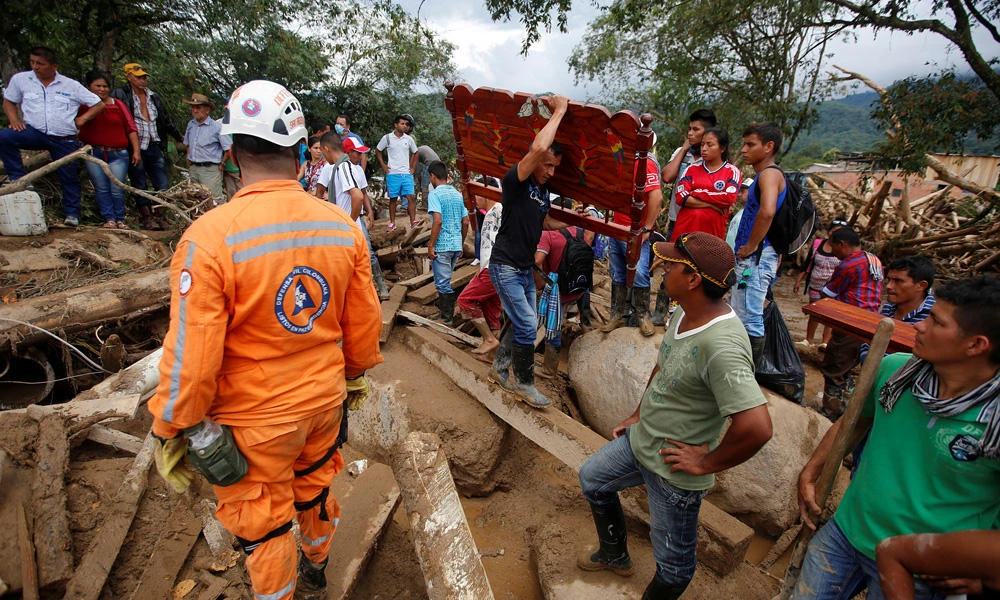 People recover their belongings after flooding and mudslides caused by heavy rains, leading several rivers to overflow, pushing sediment and rocks into buildings and roads, in Mocoa, Colombia, on Sunday. (REUTERS/Jaime Saldarriaga)