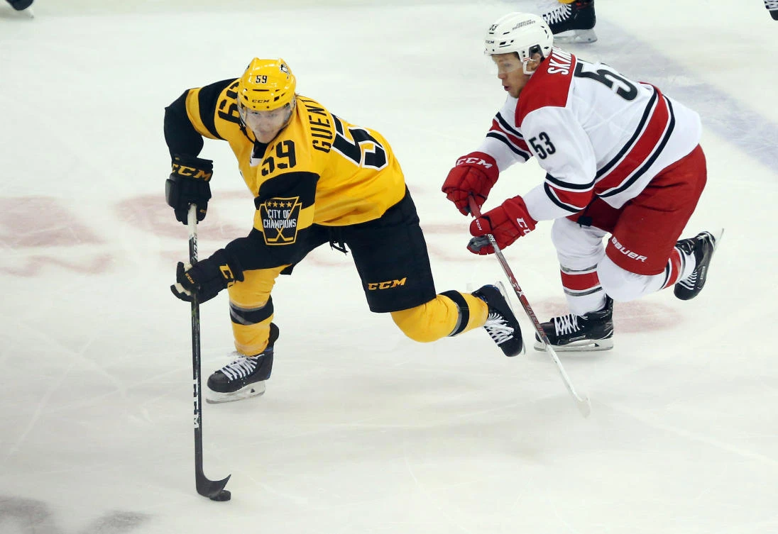 Pittsburgh Penguins center Jake Guentzel (59) skates with the puck as Carolina Hurricanes left wing Jeff Skinner chases during the second period at the PPG PAINTS Arena on Sunday.(USA TODAY Sports)