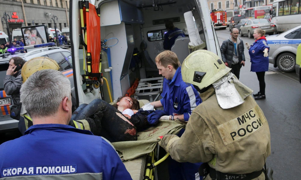 An injured person is helped by emergency services outside Sennaya Ploshchad metro station, following explosions in two train carriages at metro stations in St. Petersburg, Russia, on Monday. (REUTERS/Anton Vaganov)