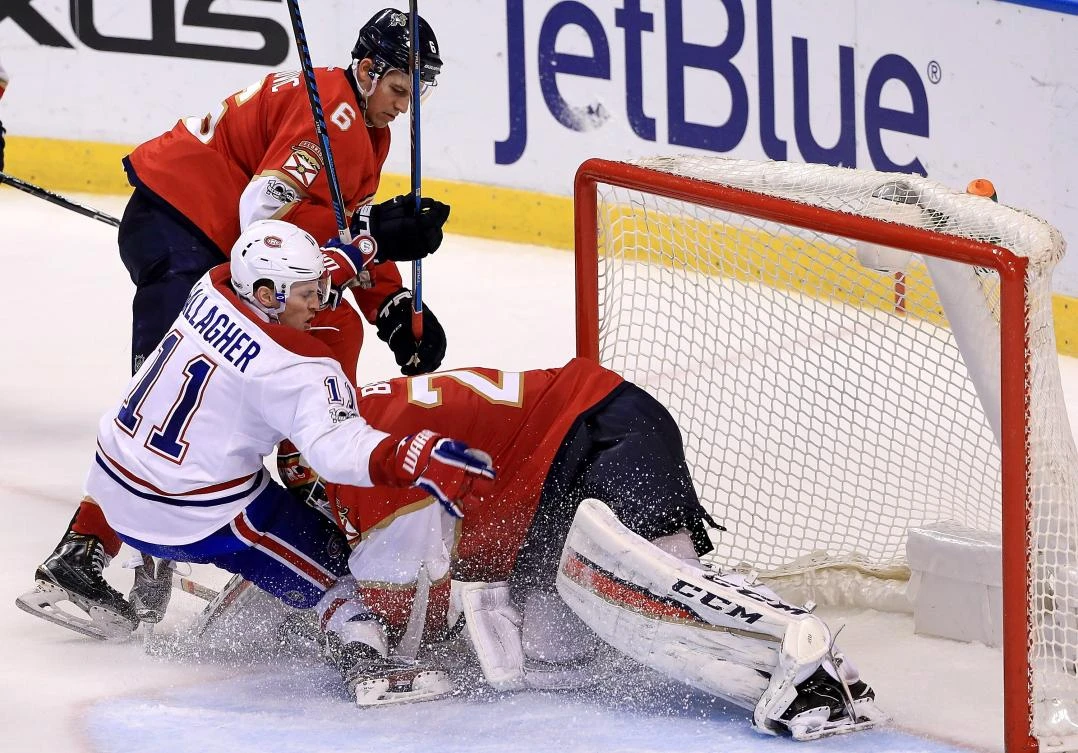 Brendan Gallagher (11) of the Montreal Canadiens collides with Reto Berra (20) of the Florida Panthers during a game at BB&T Center in Sunrise, Florida, on Monday night. (AFP)