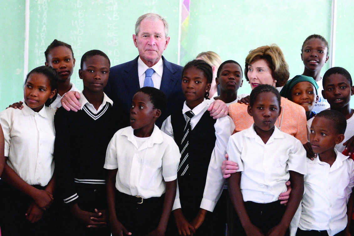 Former US President George W. Bush and his wife Laura with the students of the Theresanyo Primary school in Gaborone, Botswana. (AFP)
