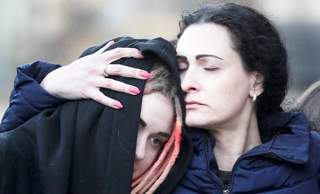 Two women react at a symbolic memorial at Technologicheskiy Institute subway station in St. Petersburg, Russia, on Tuesday. (AP)