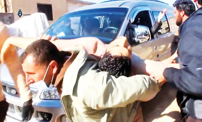 A video grab shows a Syrian man carrying a victim of a chemical attack in Khan Sheikhun, Idlib, Tuesday. (AP)