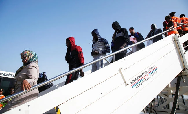 Gambian migrants deported from Libya arrive at the airport in Banjul, Gambia on Tuesday. (REUTERS)