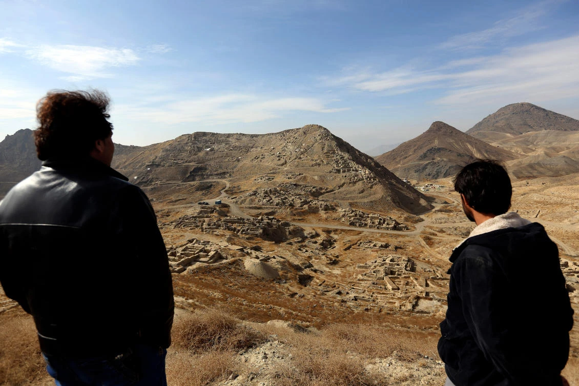 Abdul Qadir Timor, director of archaeology at the Ministry of Information and Culture, left, looks at the view of Mes Aynak valley, some 40 kilometers (25 miles) southwest of Kabul, Afghanistan. (AP)
