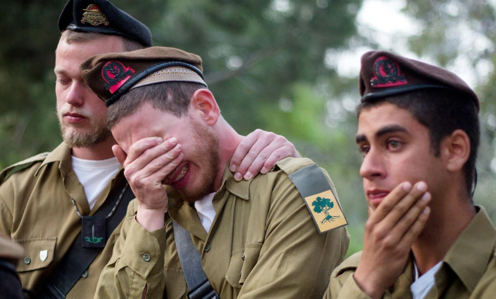 Israeli soldiers from the Golani brigade mourn during the funeral of Sergeant Elichai Taharlev on Mt. Herzl Military Cemetery in Jerusalem on Thursday. Taharlev was killed after a Palestinian rammed his vehicle into a group of people in the West Bank on Thursday morning. (AP Photo/Ariel Schalit)