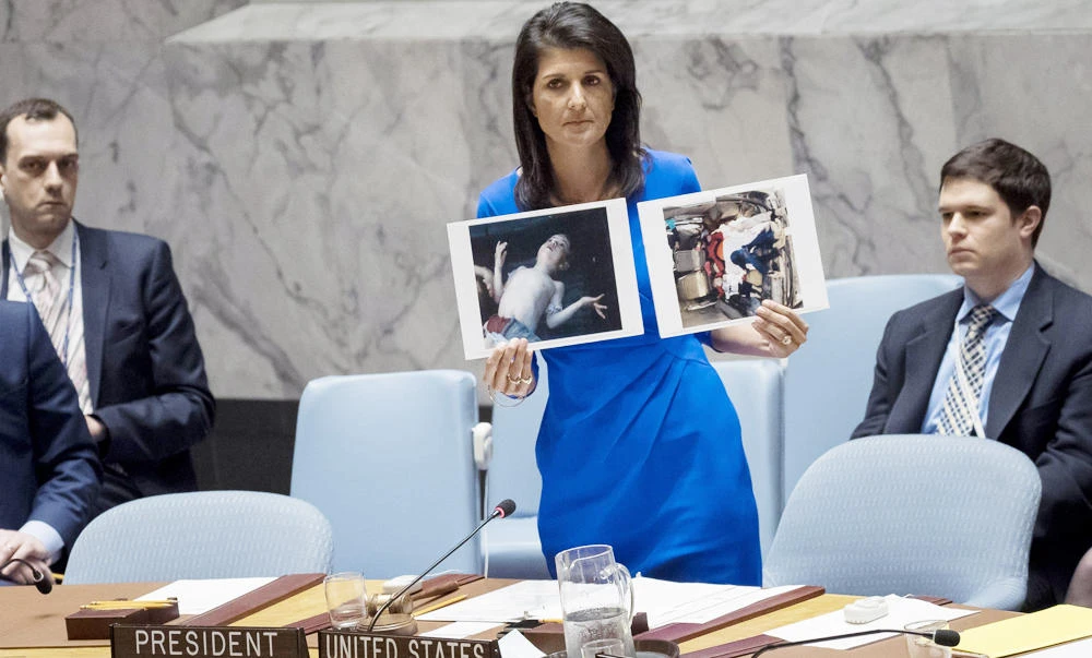 US Ambassador to the United Nations Nikki Haley holds up photos of victims of the Syrian chemical attack during a meeting of the United Nations Security Council at UN headquarters in New York City on Thursday. (Drew Angerer/Getty Images/AFP)