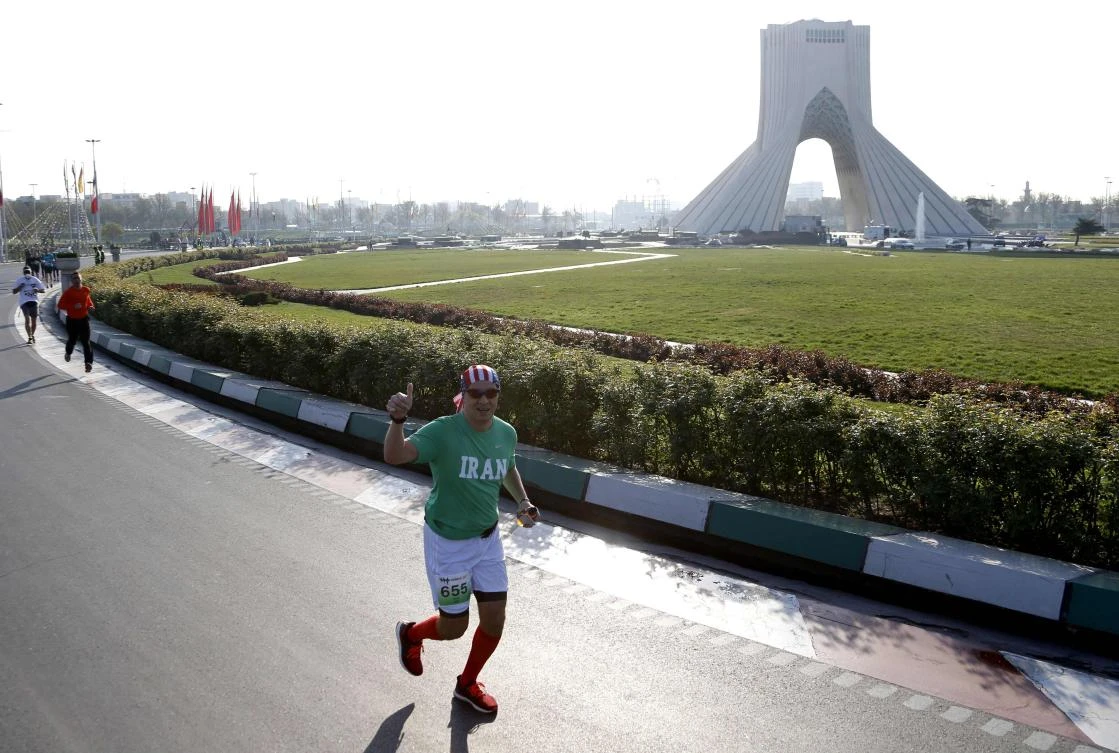 An Iranian American takes part in the first international Tehran marathon at Azadi Square in the Iranian capital (AFP)