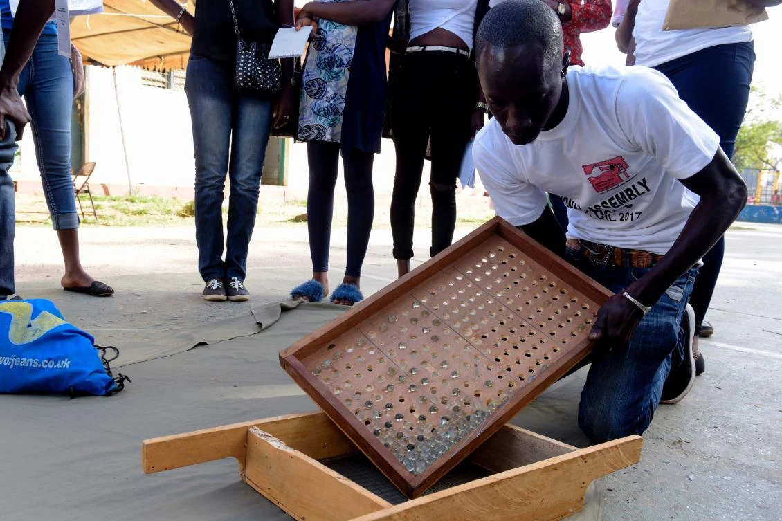 Electoral officials count marbles used for voting. (AFP)
