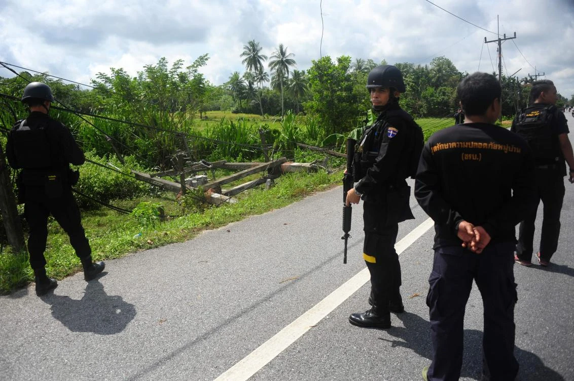Thai Navy rangers survey the scene where a high voltage tower was blown up. (AFP)