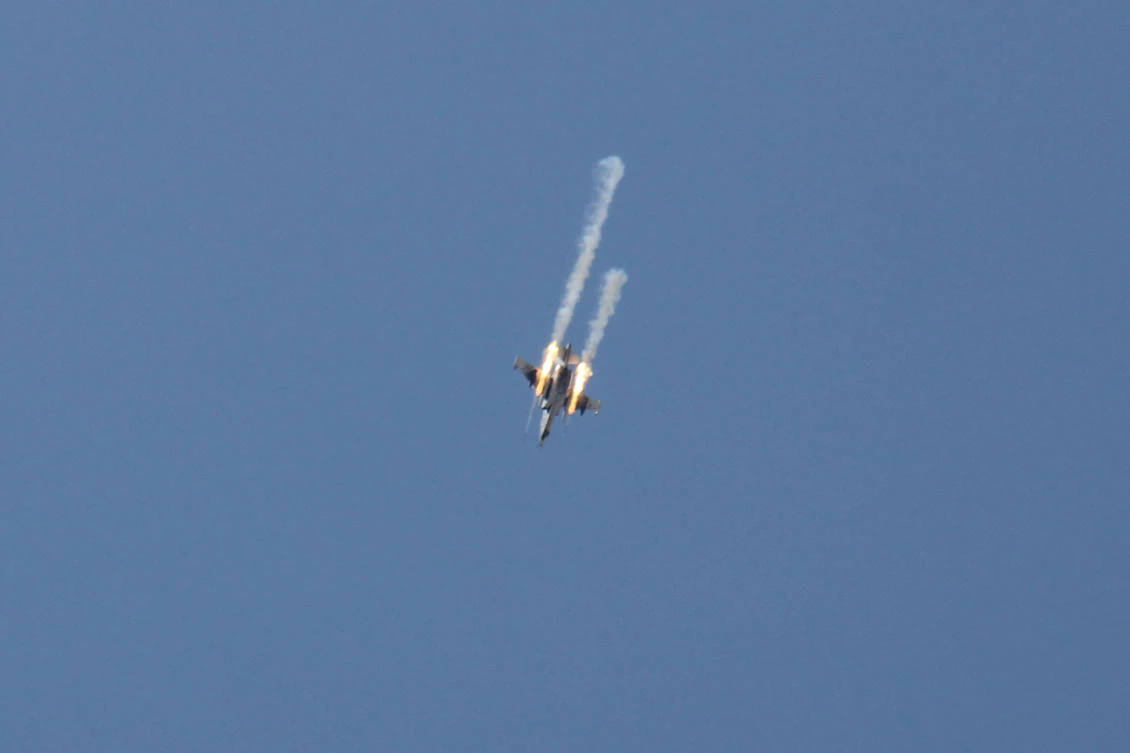 A Syrian army jet firing rockets over the village of Rahbet Khattab in the Hama province. (AFP)