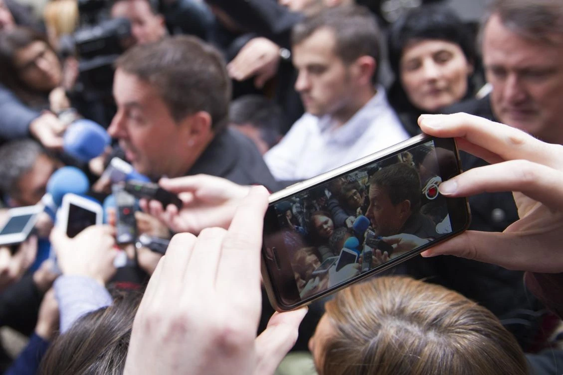 A journalist takes a picture as Basque separatist leader Arnaldo Otegi speaks with journalists. (AFP)
