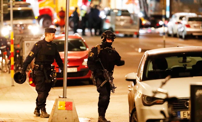 Swedish police officers patrol on Saturday, the area where a stolen truck was driven through a crowd outside a department in Stockholm on Friday. (AFP)