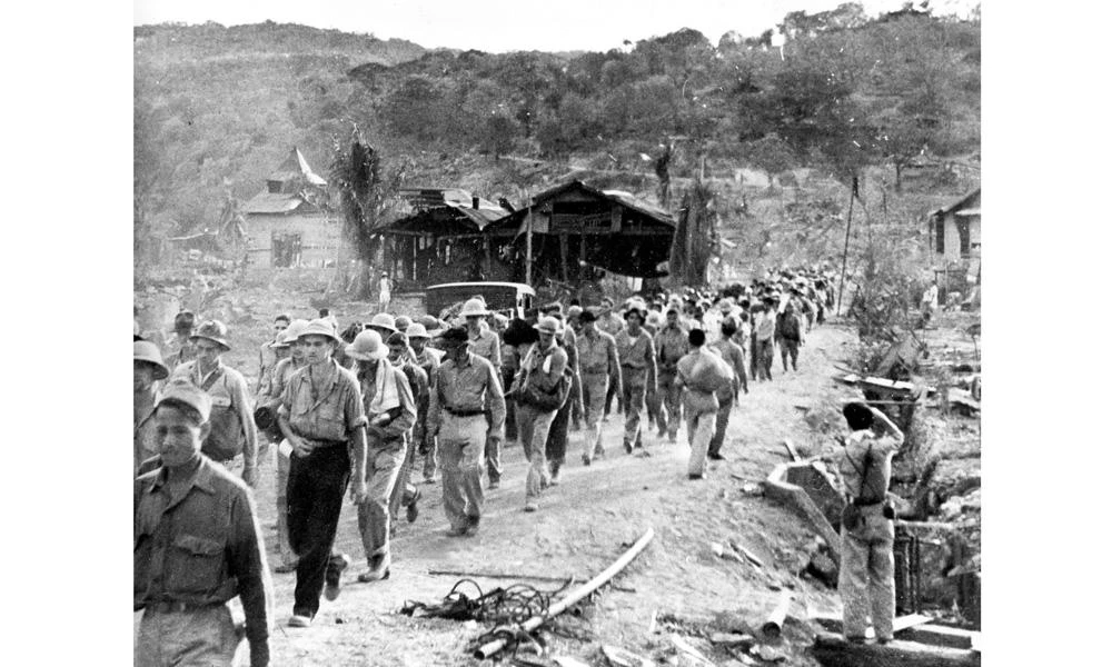In this 1942 file photo American and Filipino prisoners of war captured by the Japanese are shown at the start of the Death March after the surrender of Bataan on April 9 near Mariveles in the Philippines, during World War II. (AP Photo/File)
