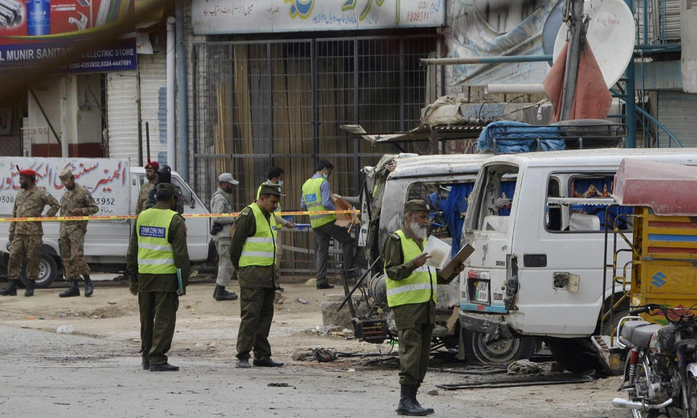 Pakistani security officials inspect the scene of a suspected Taliban bomb attack in Lahore on April 5, 2017. Police on Saturday said they killed 10 Taliban gunmen in an early morning shootout Saturday in Lahore, officials said. (AFP / ARIF ALI)