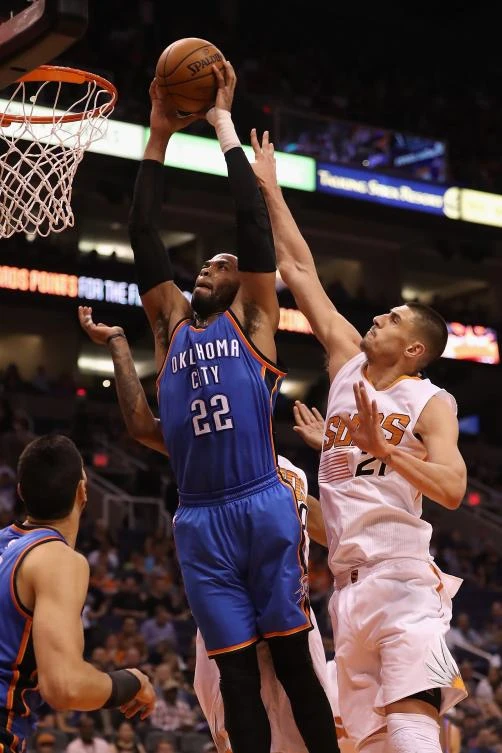 Taj Gibson (22) of the Oklahoma City Thunder slam dunks the ball past Alex Len (21) of the Phoenix Suns during the first half of their NBA game at Talking Stick Resort Arena in Phoenix, Arizona, on Friday night. (AFP)