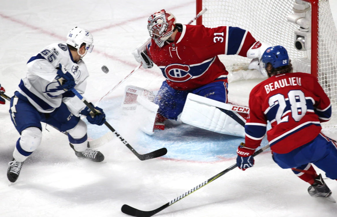 Montreal Canadiens goalie Carey Price (31) makes as save against Tampa Bay Lightning center Yanni Gourde (65) and defenseman Nathan Beaulieu (28) during the first period at Bell Centre on Friday night. (USA TODAY Sports)
