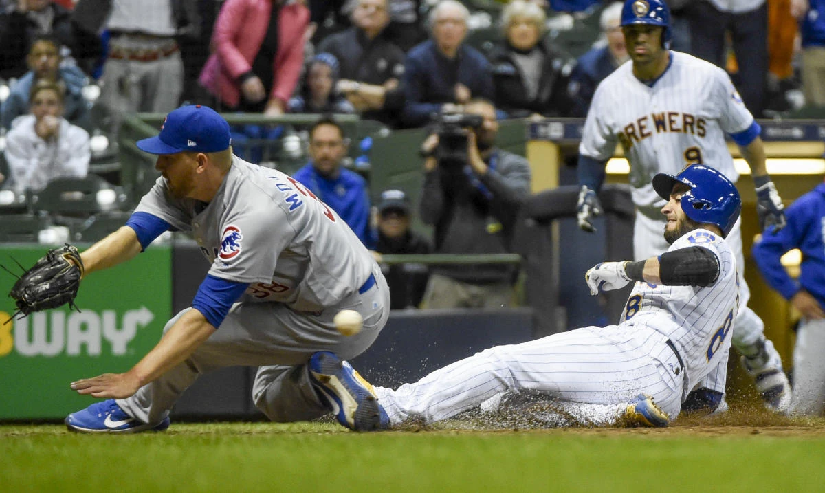 Milwaukee Brewers left fielder Ryan Braun (8) scores the winning run on a wild pitch as Chicago Cubs pitcher Mike Montgomery (38) drops the ball in the eleventh inning at Miller Park on Friday night. (USA TODAY Sports)