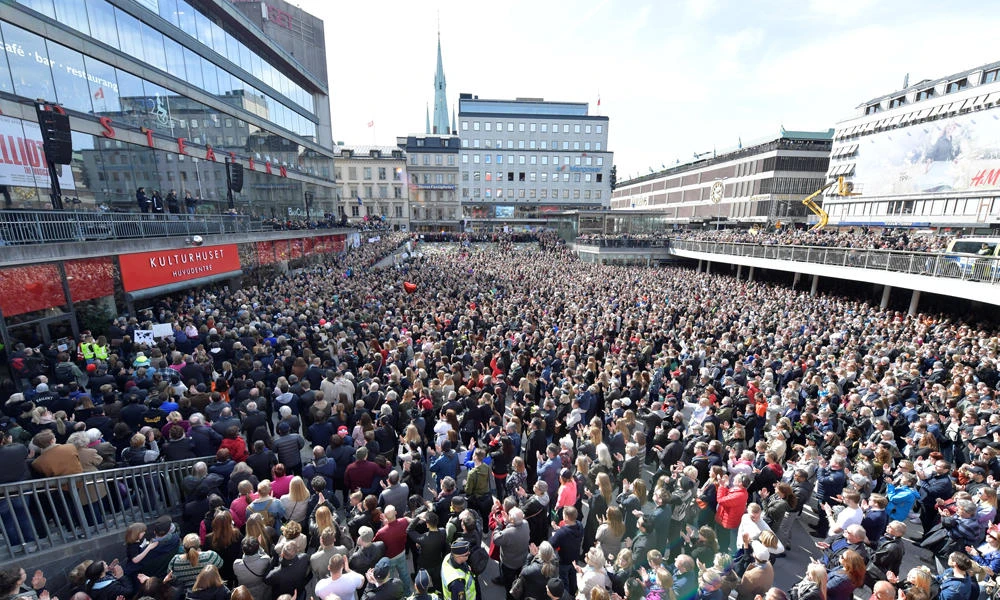 People gather in Sergels torg in central Stockholm on Sunday for a "Lovefest" vigil against terrorism following Friday's attack. (TT NEWS AGENCY/Maja Suslin via Reuters)
